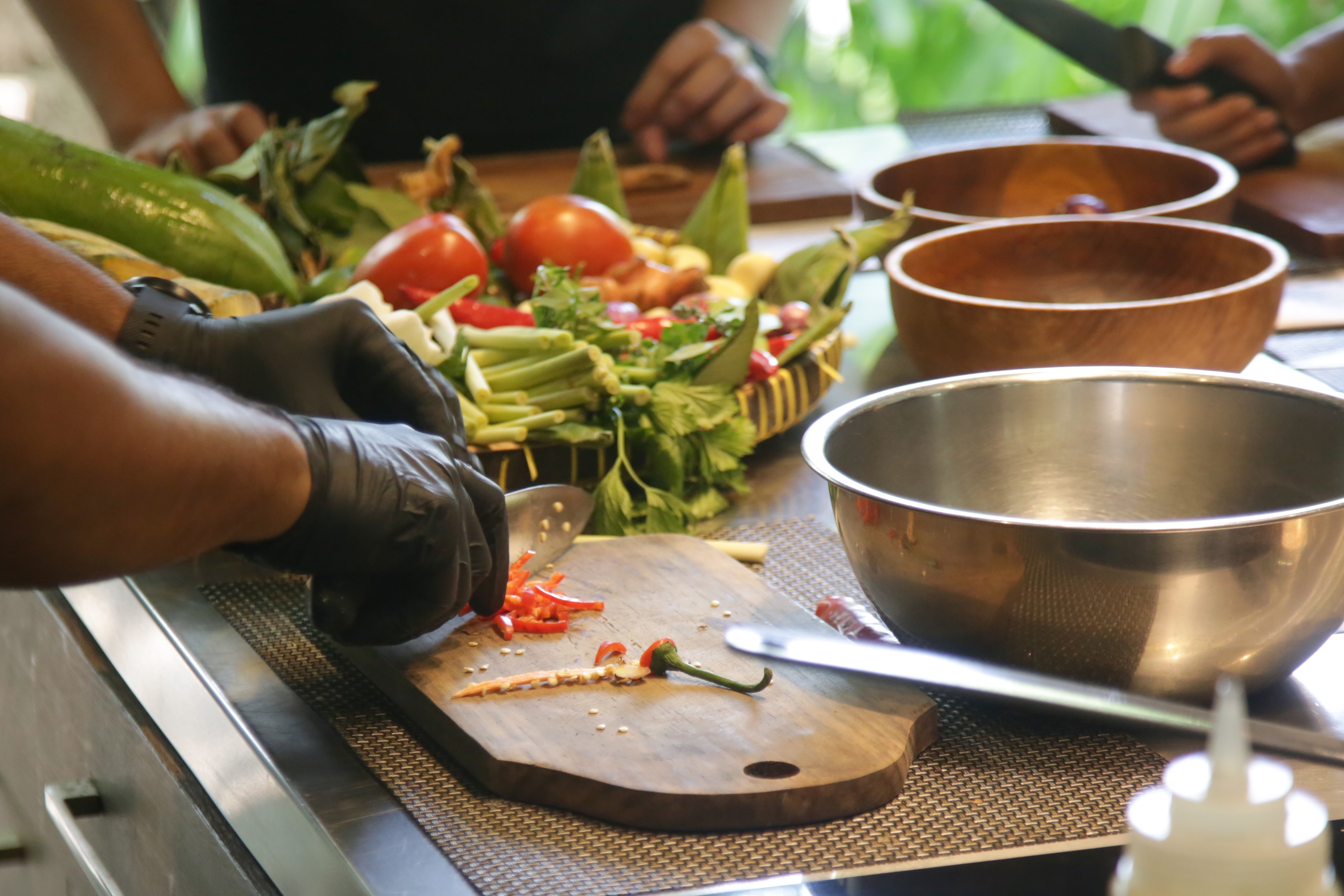 Adult chopping vegetables at a cooking class