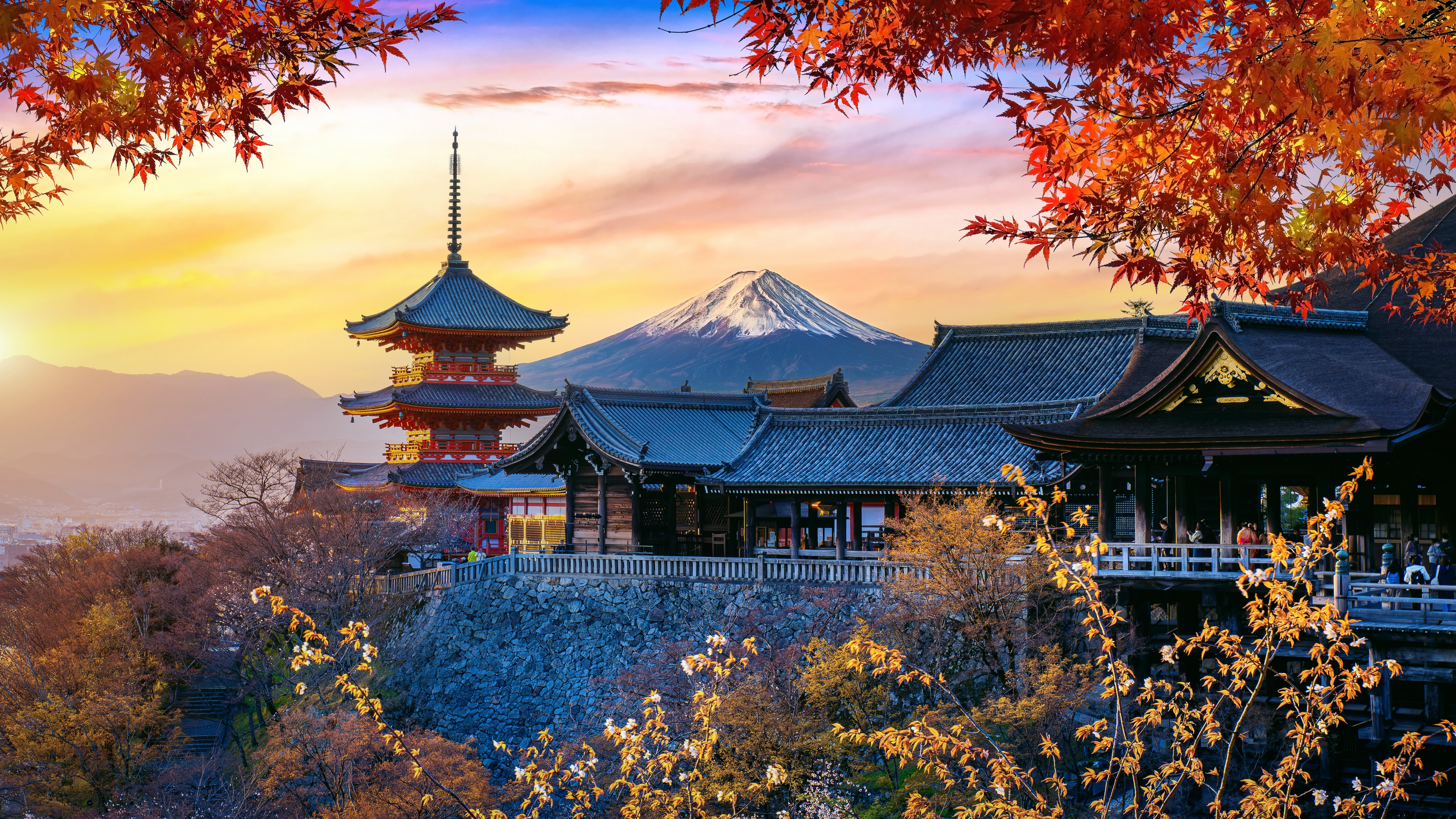 Traditional Japanese houses and autumnal leaves with Mount Fuji in the background