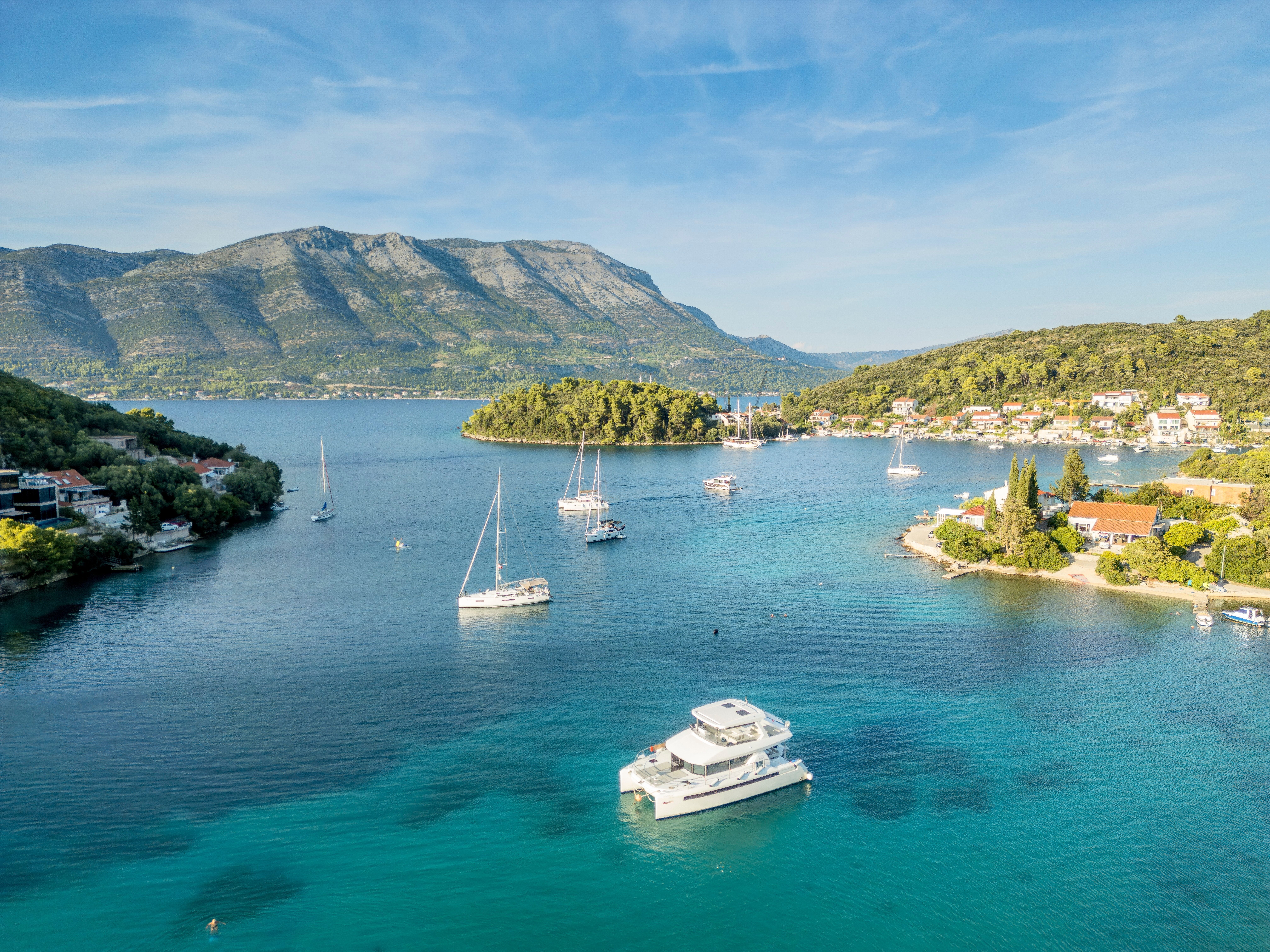 Boats dotting the clear waters around Korcula Island, Croatia