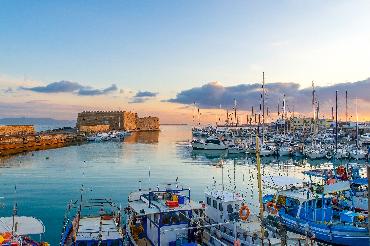 Fishing boats at the port in Heraklion, Crete at sunset