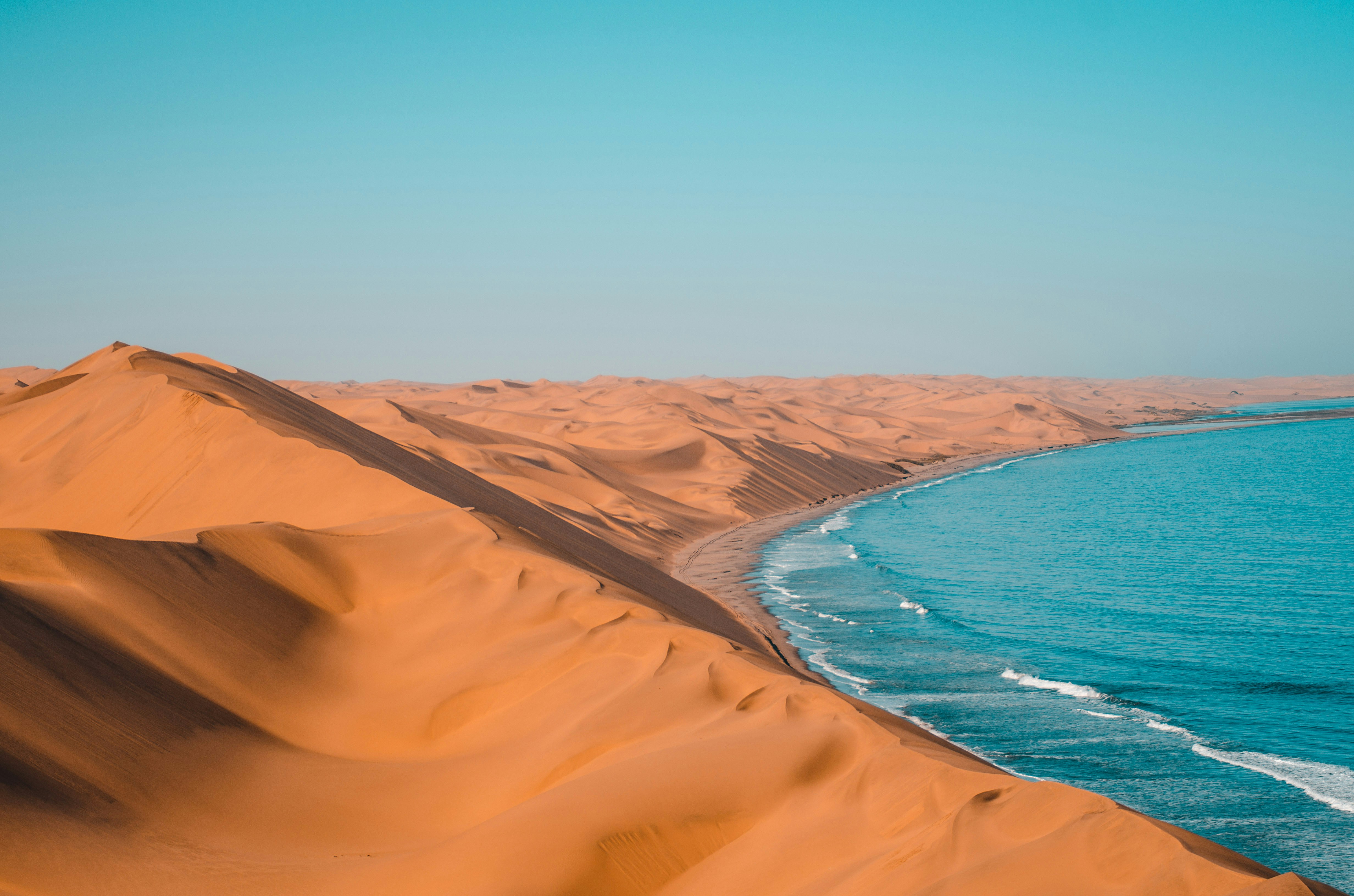 Red dunes meet the blue sea at Sandwich Harbour, Namibia