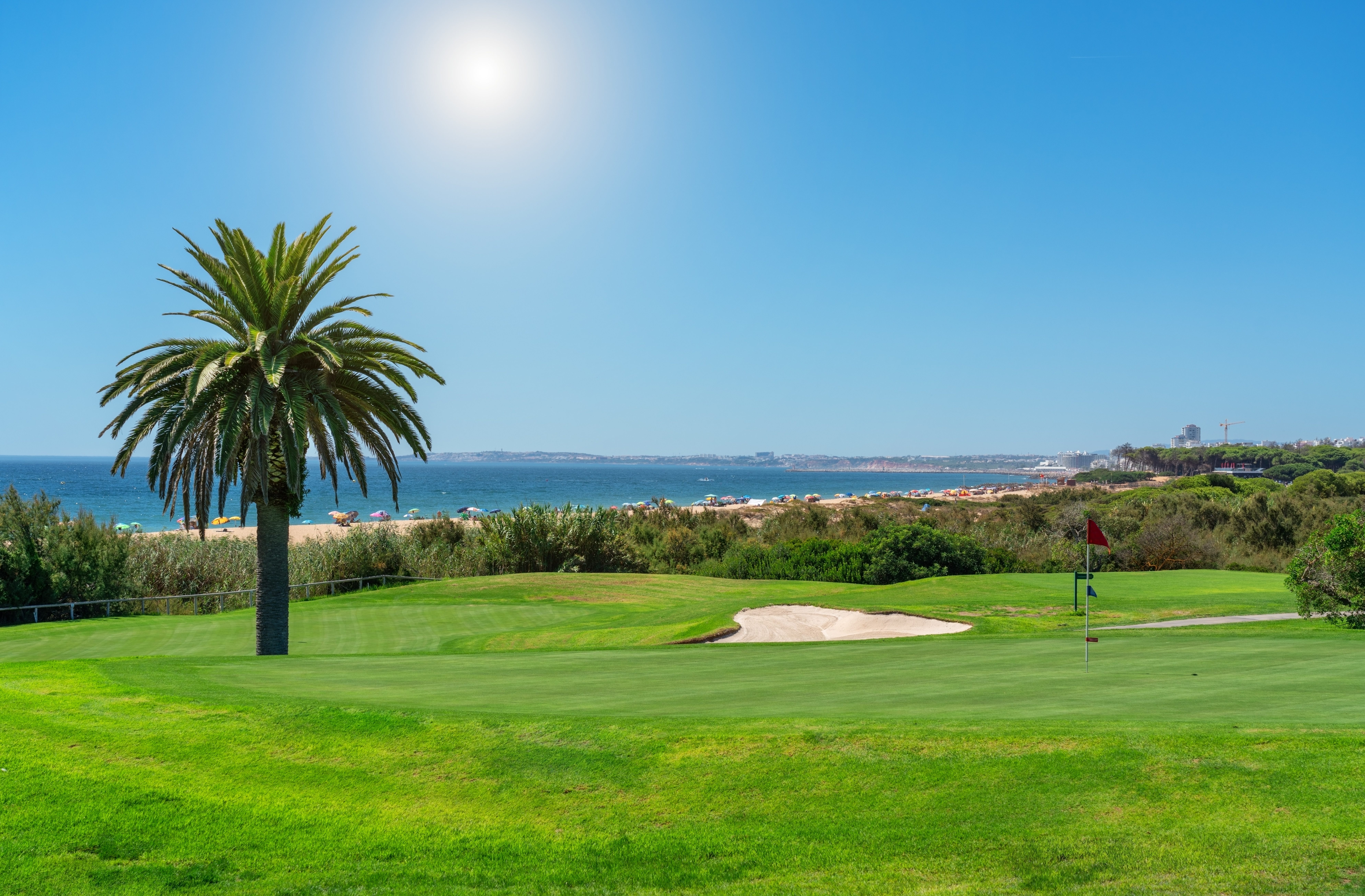 Golf course with a palm tree backed up the sea in the Algarve, Portugal