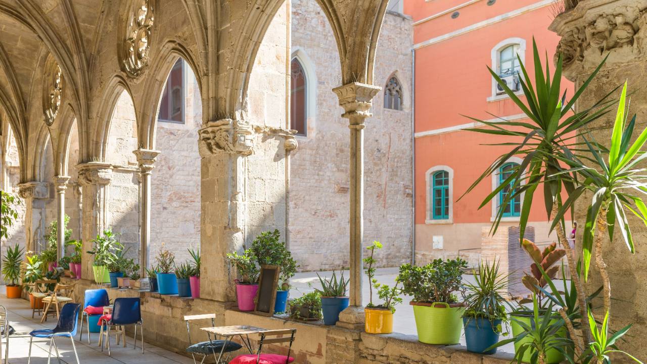 Archways of a cafe in a sunny square in El Born, Barcelona, Spain